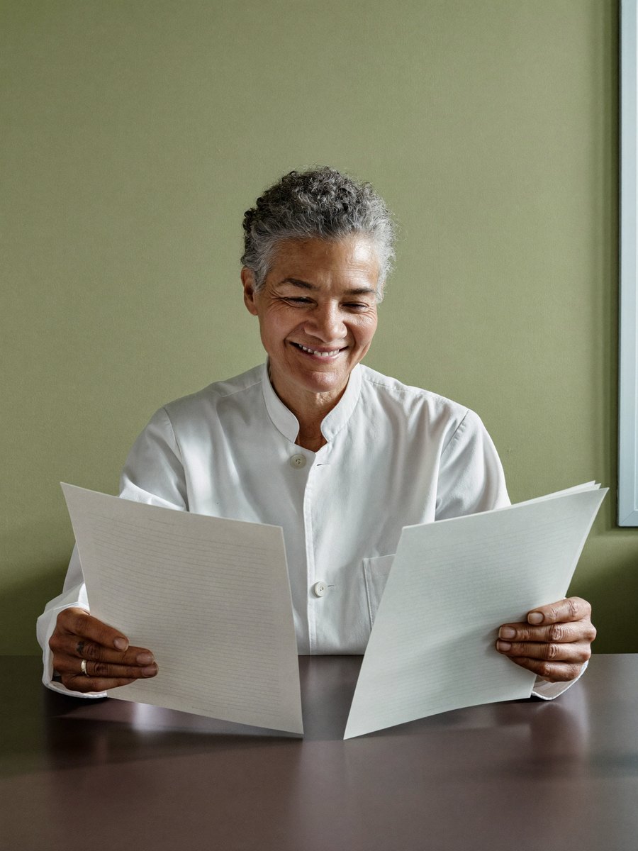 A scientist reading a printed brief at her desk
