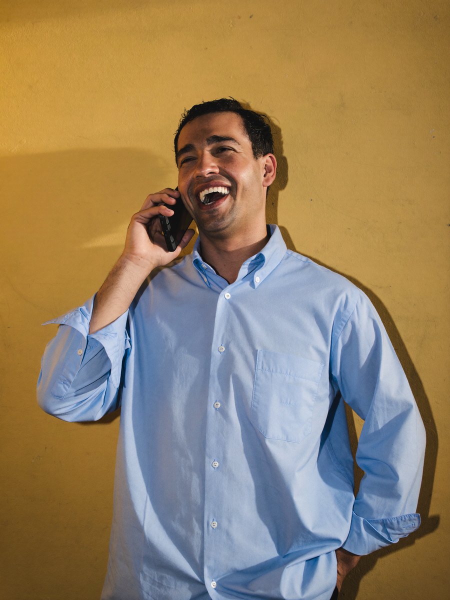 A scientist laughing as he talks on the phone