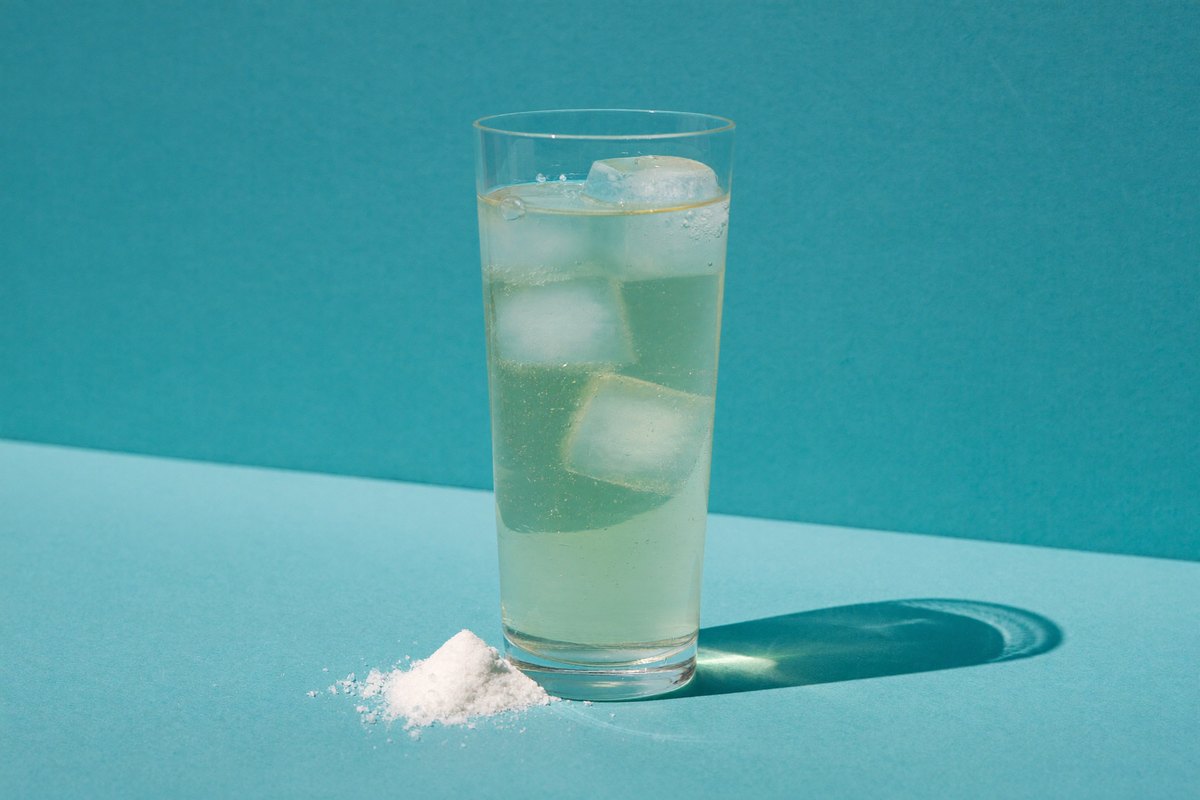 A tall glass of sparkling electrolyte drink with ice